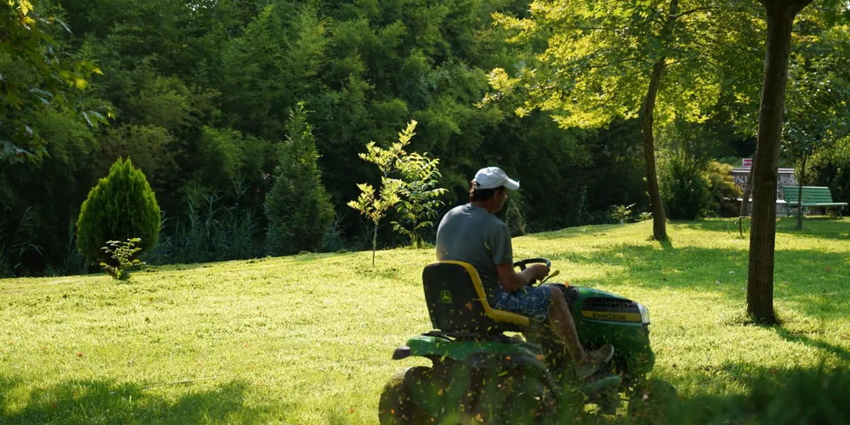 Lawn care crew mowing a residential yard in Buffalo, NY